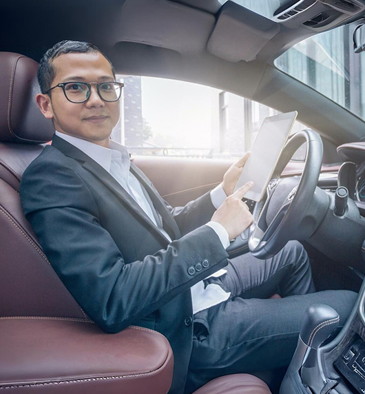 A right close up of a yellow Mercedes AMG sports car headlight on a city street