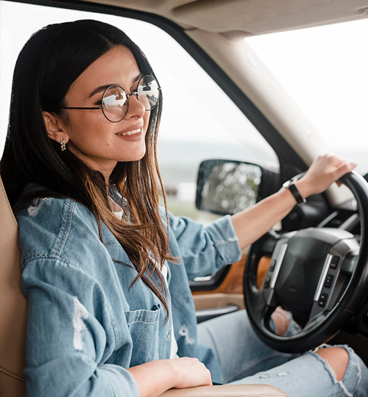 A right close up of a yellow Mercedes AMG sports car headlight on a city street