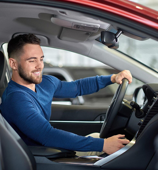 A right close up of a yellow Mercedes AMG sports car headlight on a city street