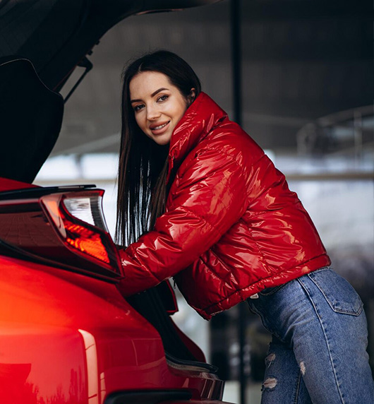 A right close up of a yellow Mercedes AMG sports car headlight on a city street