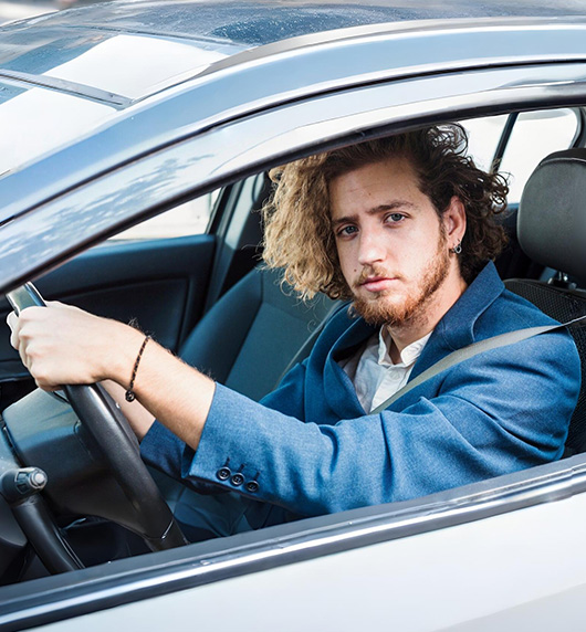 A right close up of a yellow Mercedes AMG sports car headlight on a city street