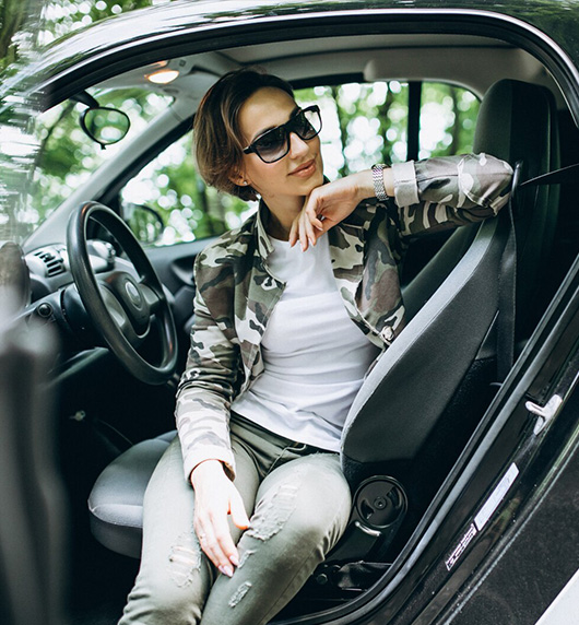 A right close up of a yellow Mercedes AMG sports car headlight on a city street