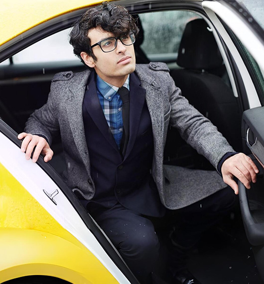 A right close up of a yellow Mercedes AMG sports car headlight on a city street